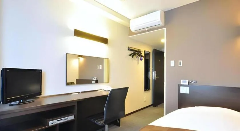 Bed in Hotel New Amami