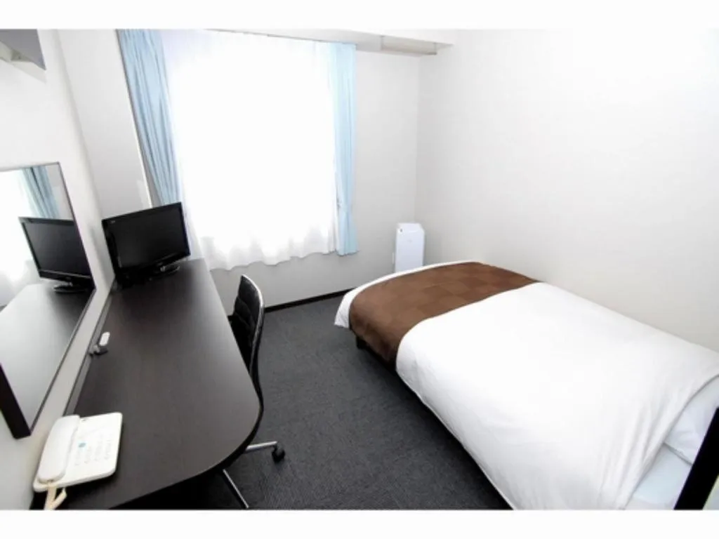 Bed in Hotel New Amami