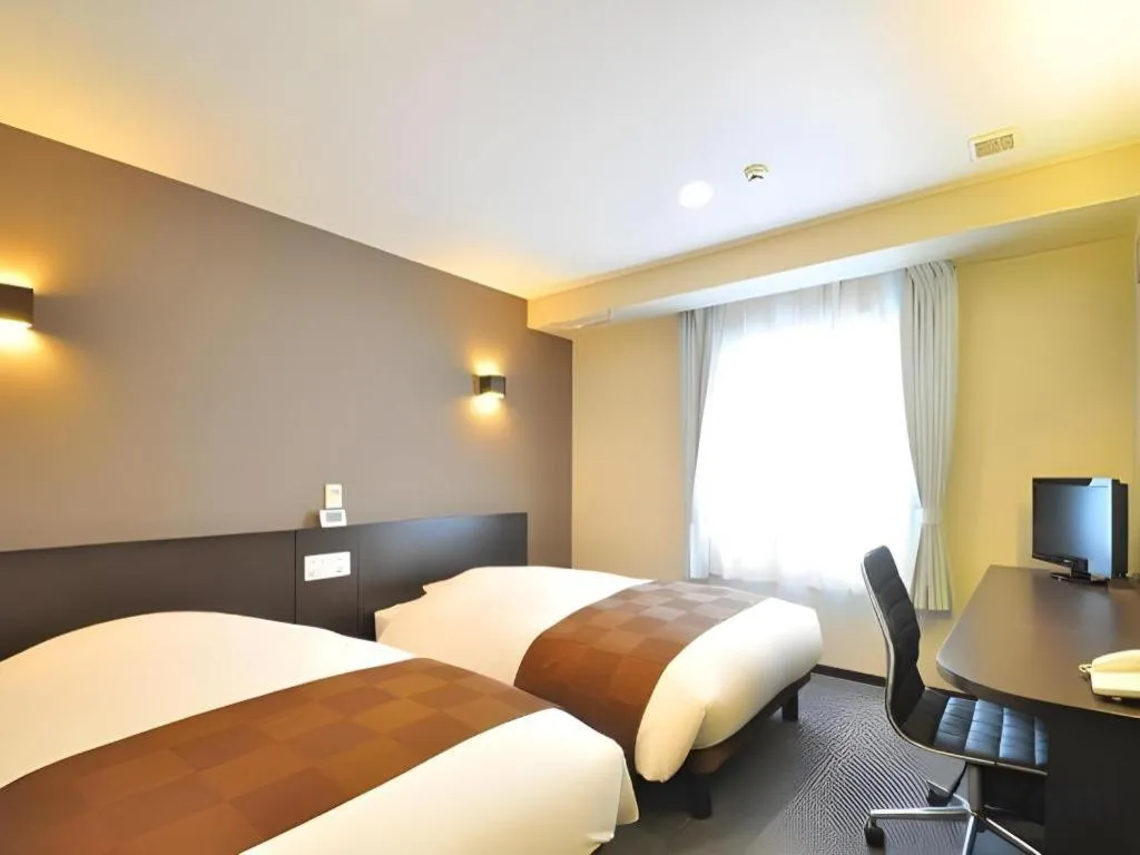 Bed in Hotel New Amami