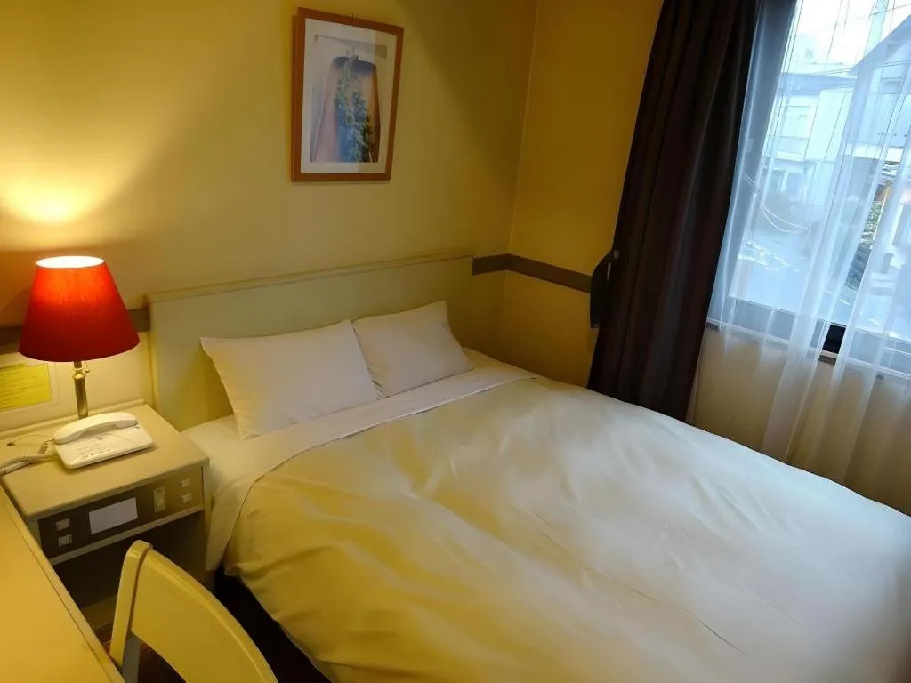 Bed in Matsumoto Wellton Hotel