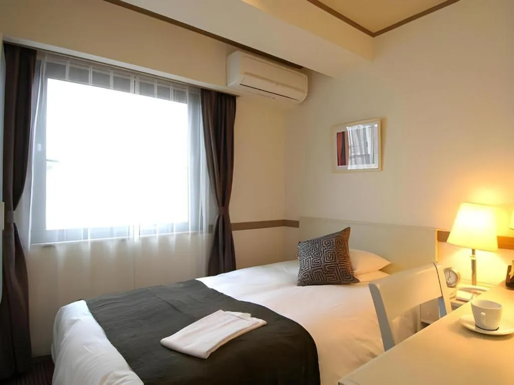 Bed in Matsumoto Wellton Hotel