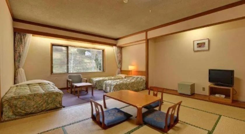 Bed in Oze Iwakura Resort Hotel