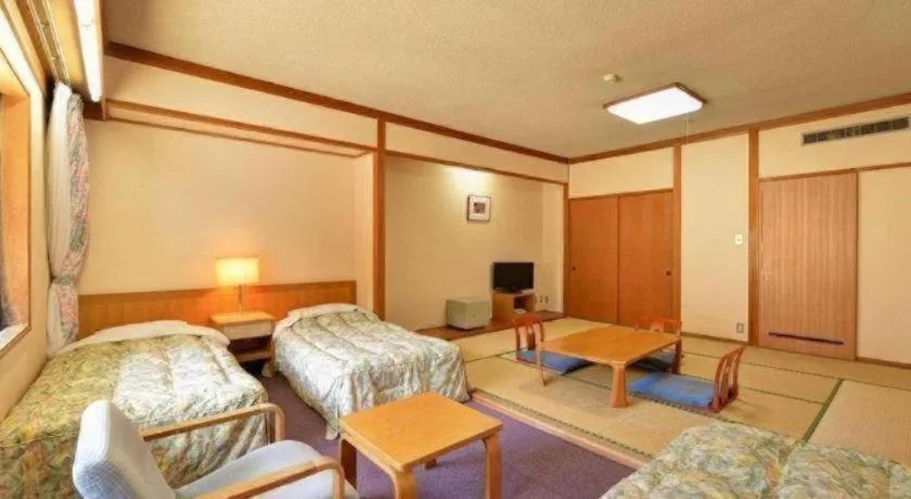 Bed in Oze Iwakura Resort Hotel