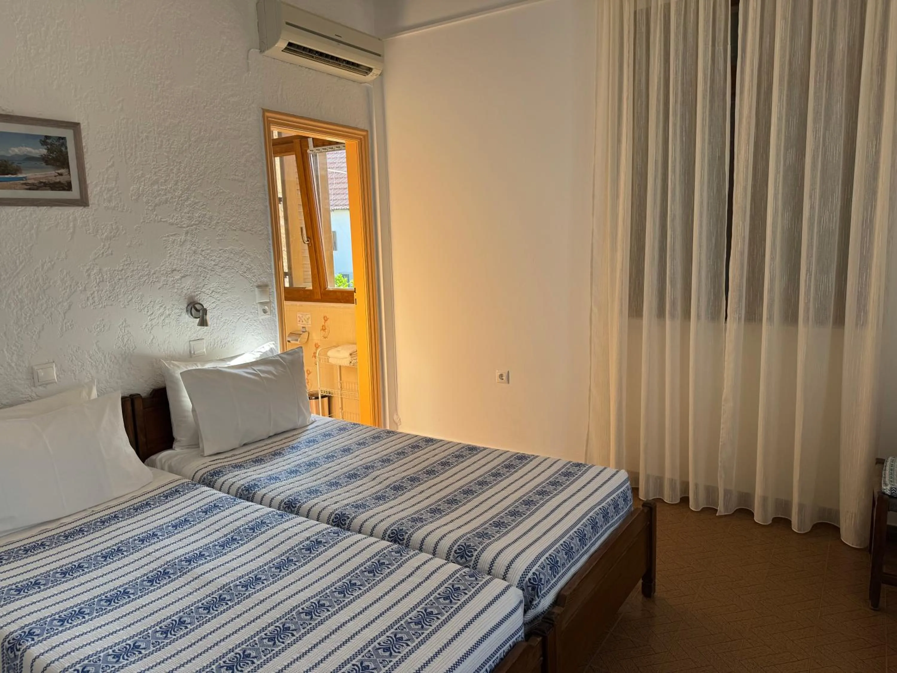 Bed in Pythaïs Hotel