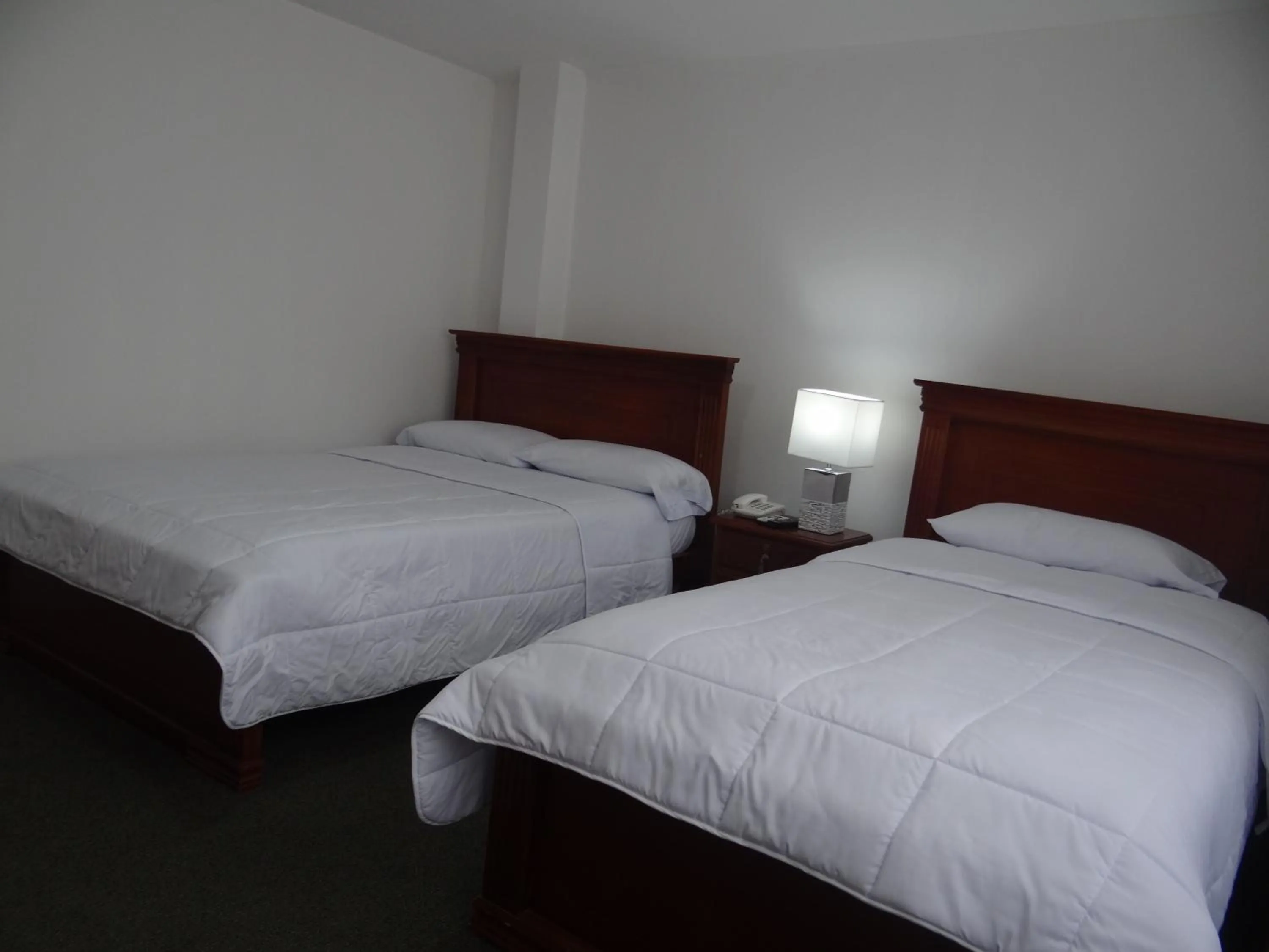 Bed in Altura Rooms & Suites