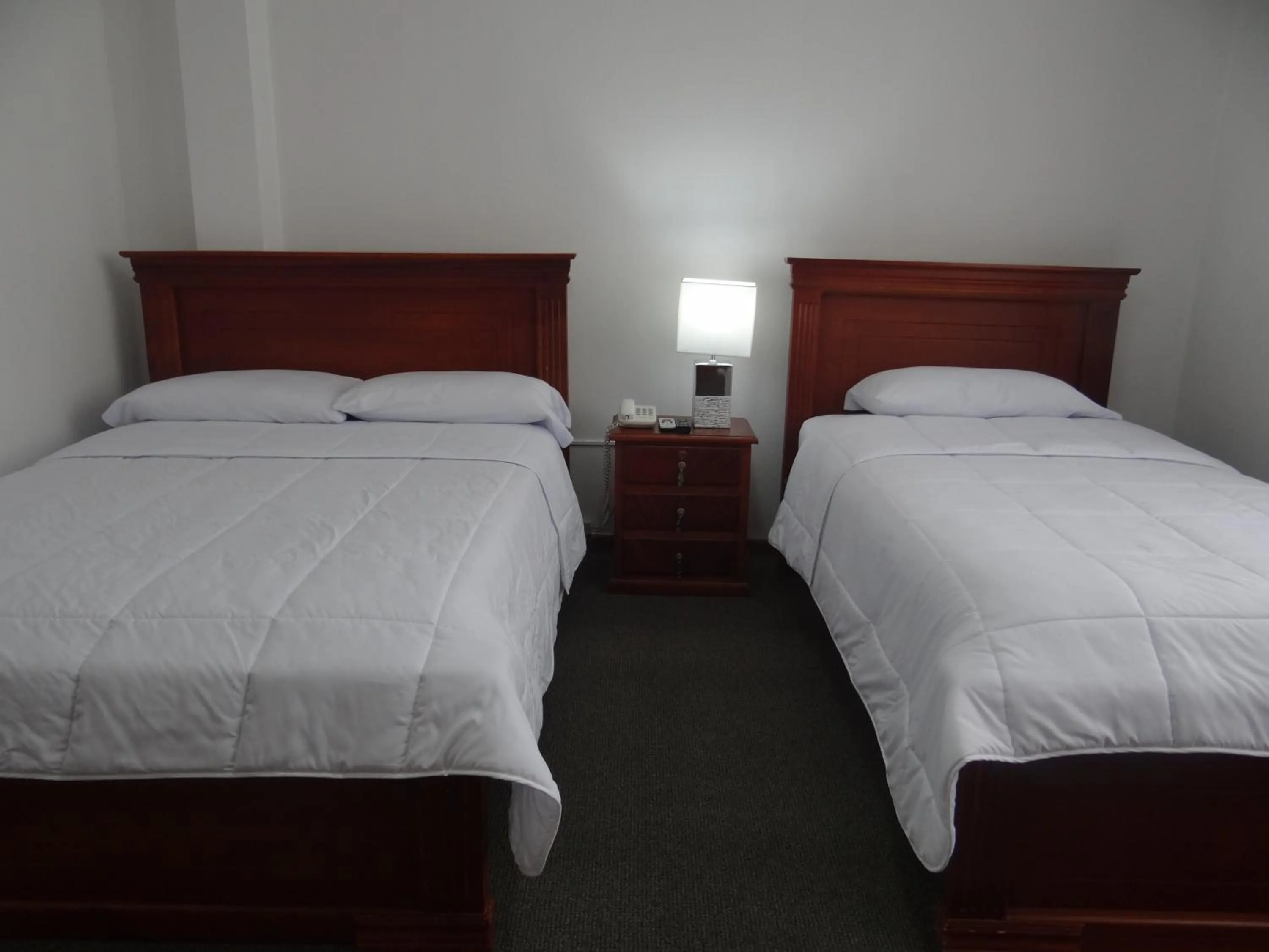 Bed in Altura Rooms & Suites