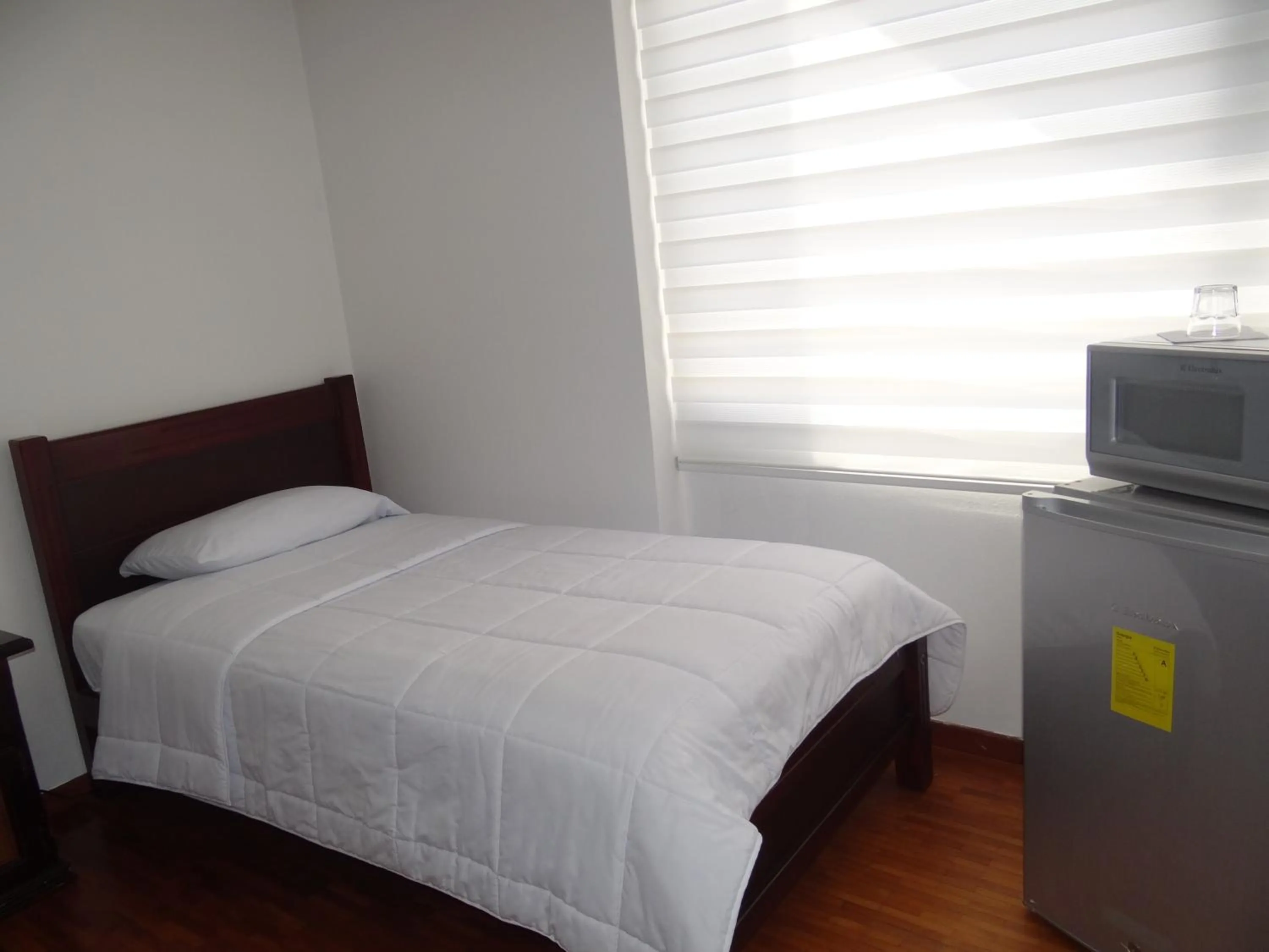 Bed in Altura Rooms & Suites