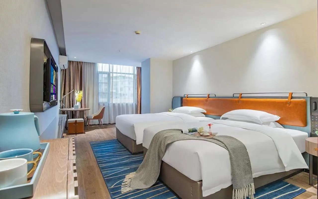 Bed in Echarm Hotel Guangzhou Jiahe Helong Branch