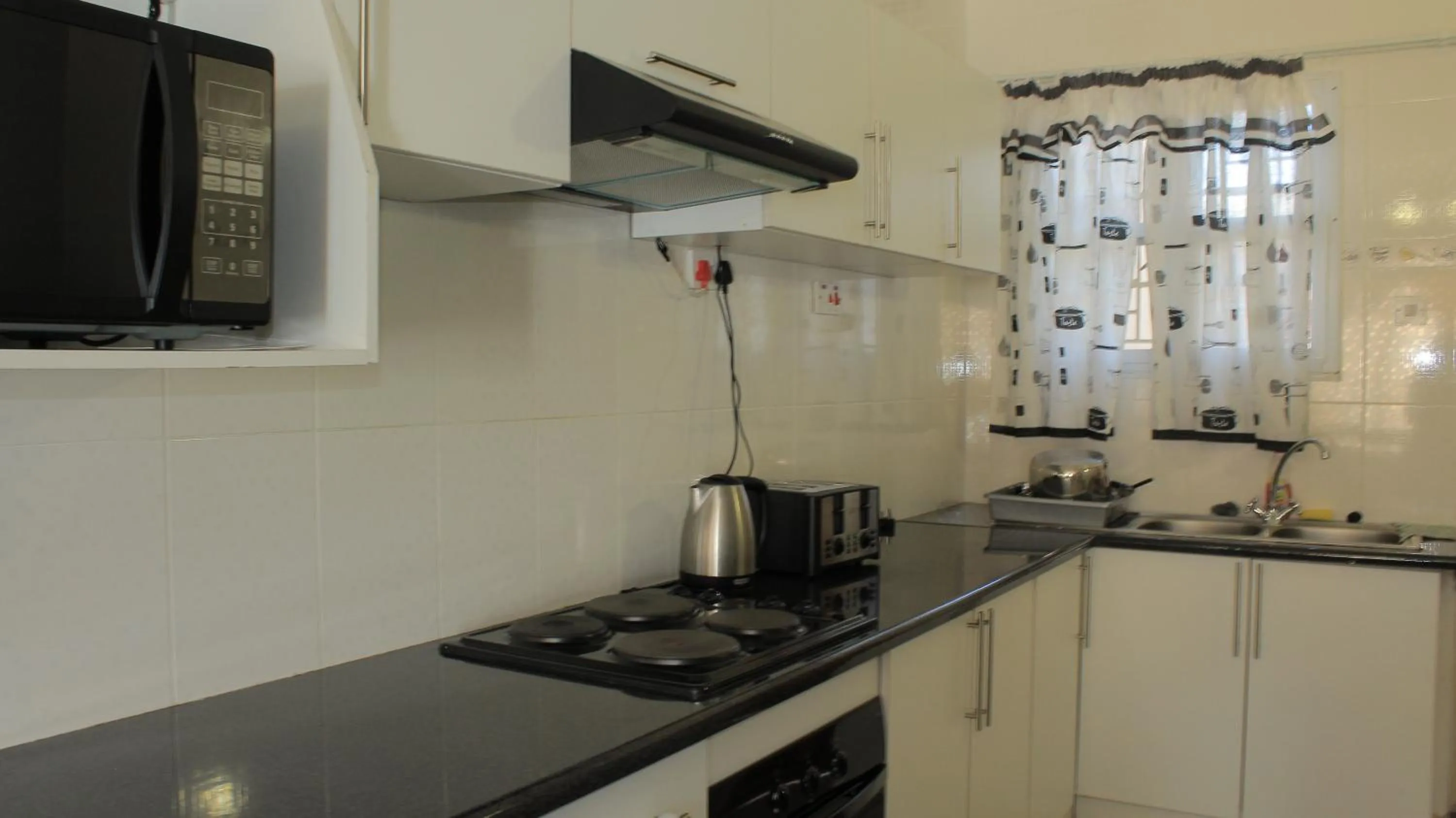 Kitchen or kitchenette in Asante Apartments