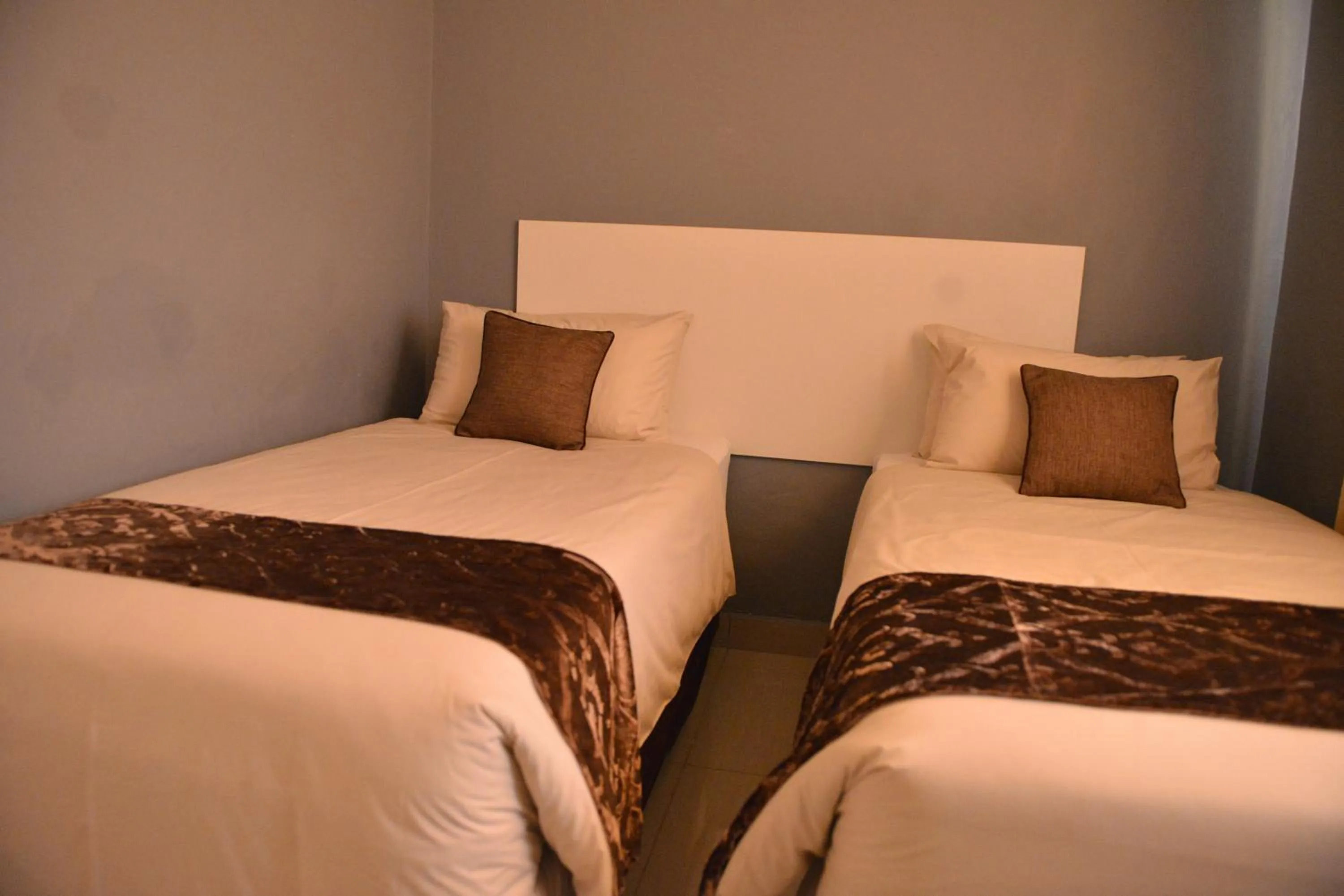 Bed in Asante Apartments