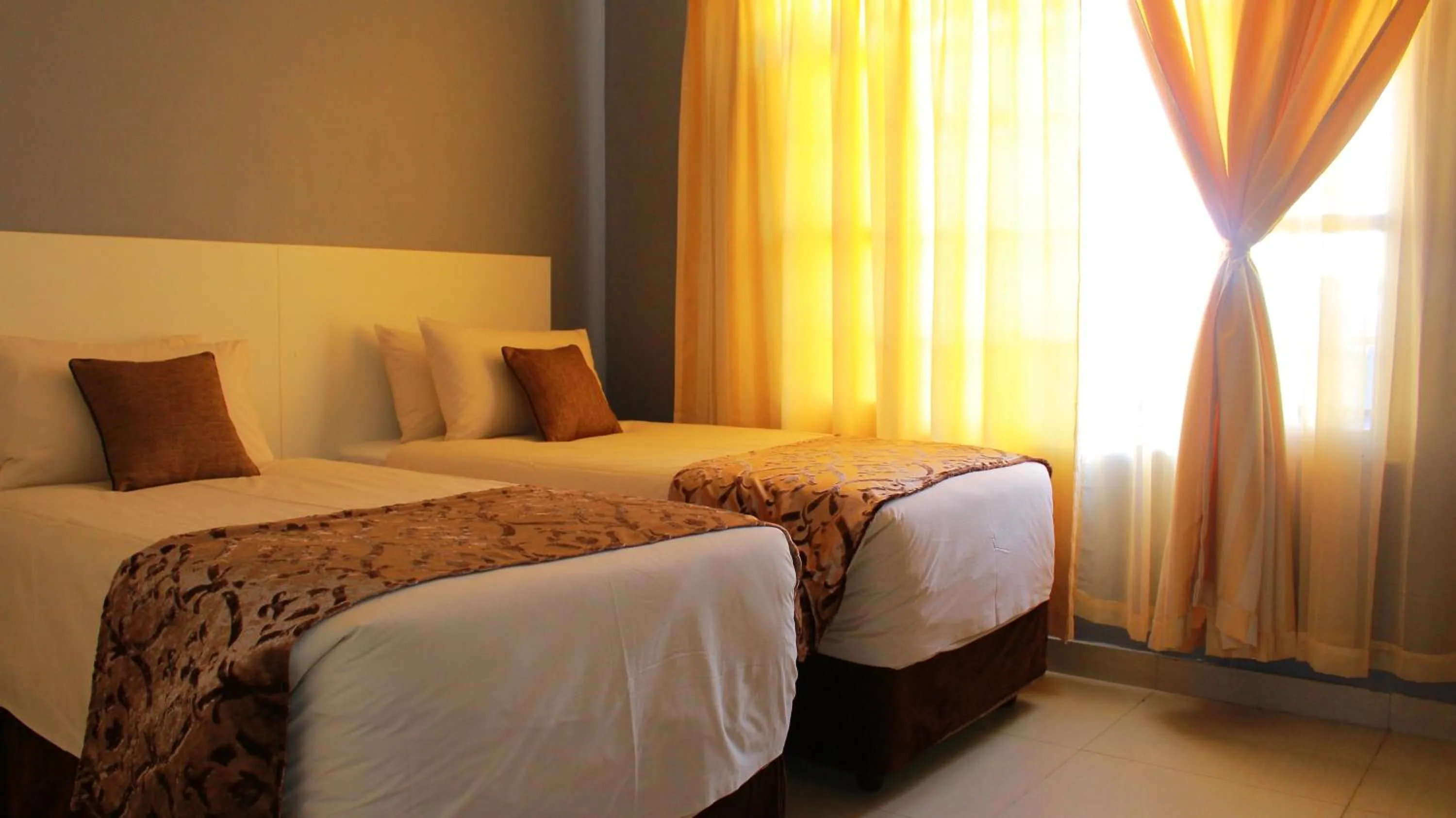 Bed in Asante Apartments