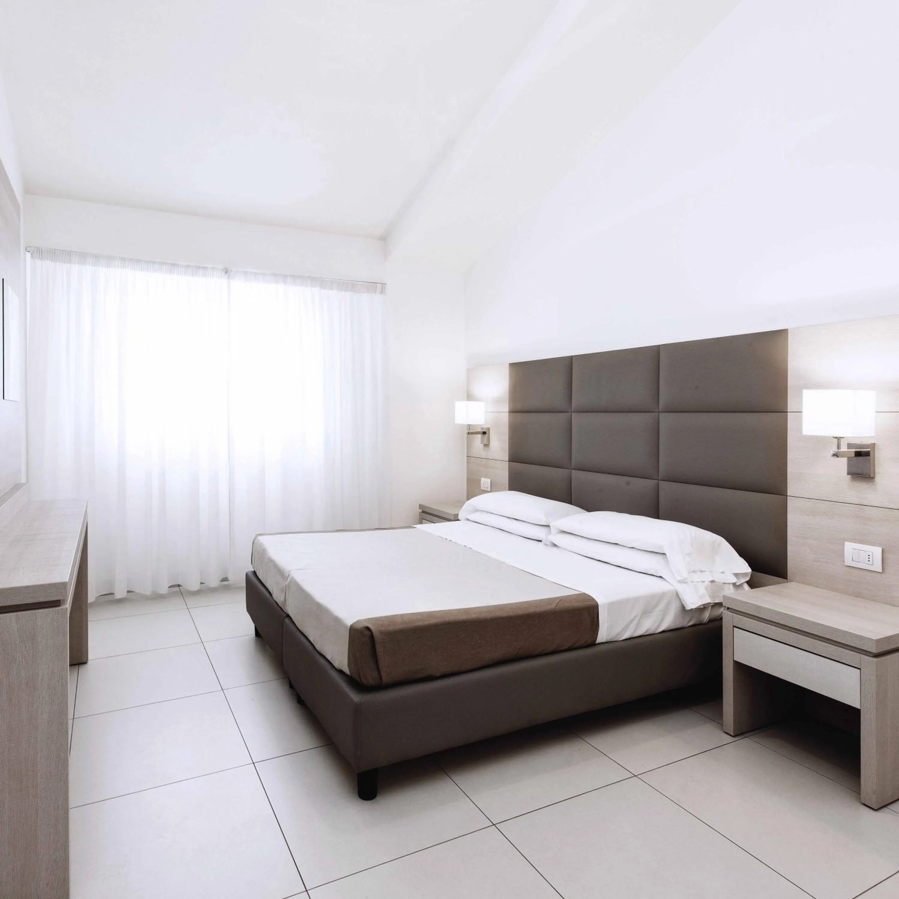 Bed in Hotel Capri & Residence