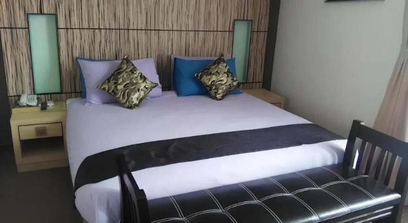 Bed in Grand Medallion Hotel