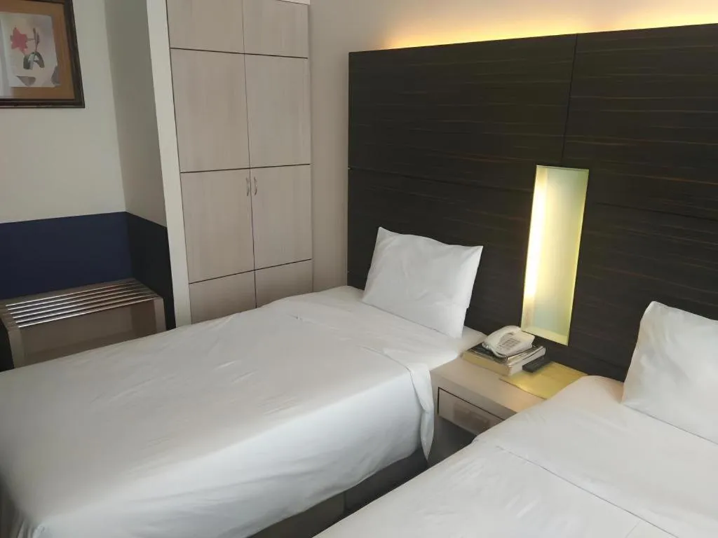 Bed in Grand Medallion Hotel