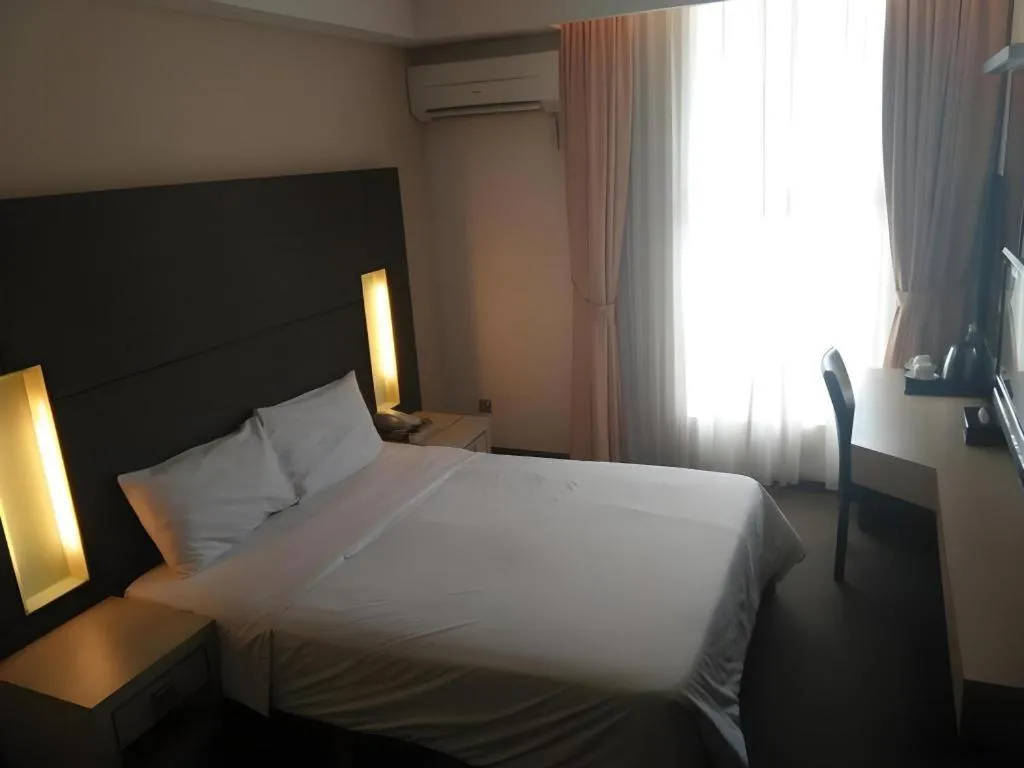 Bed in Grand Medallion Hotel