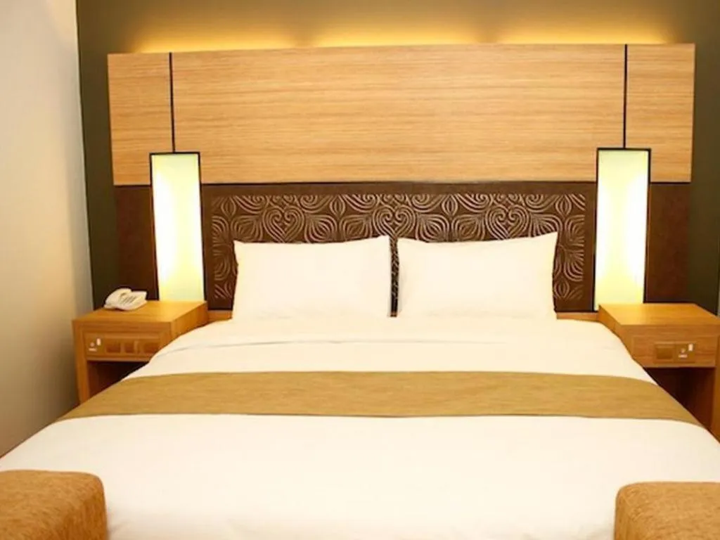 Bed in Grand Medallion Hotel