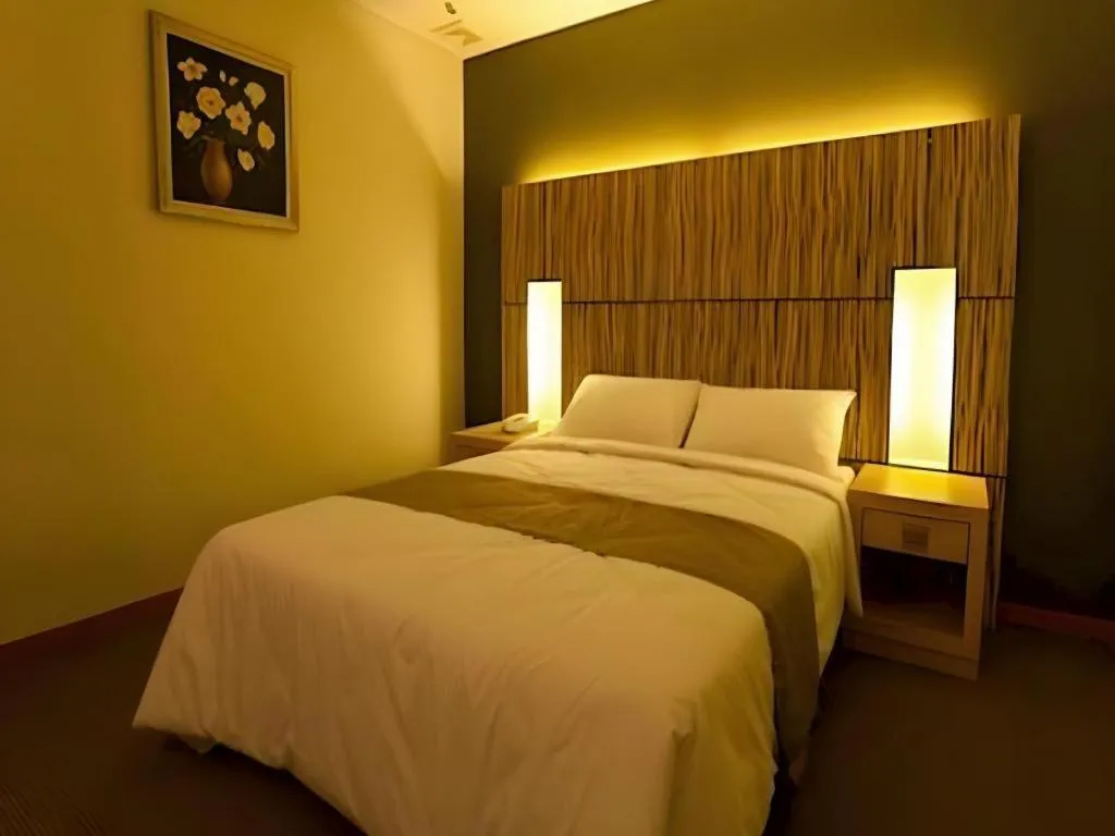 Bed in Grand Medallion Hotel