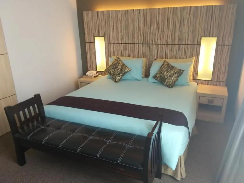 Bed in Grand Medallion Hotel