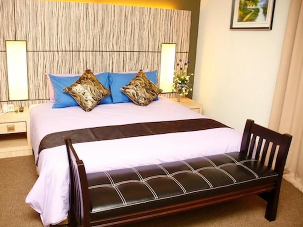 Bed in Grand Medallion Hotel