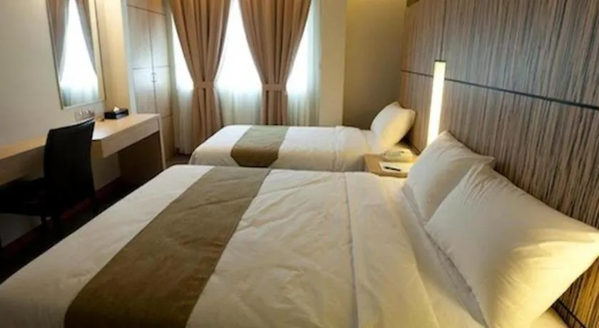 Bed in Grand Medallion Hotel