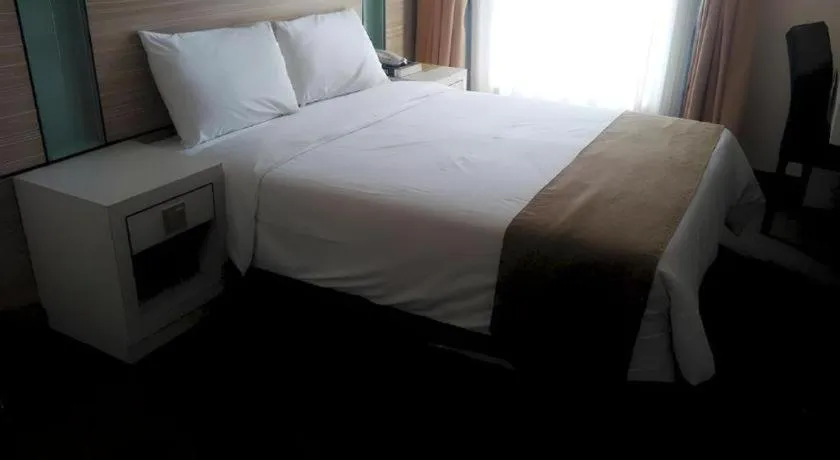 Bed in Grand Medallion Hotel