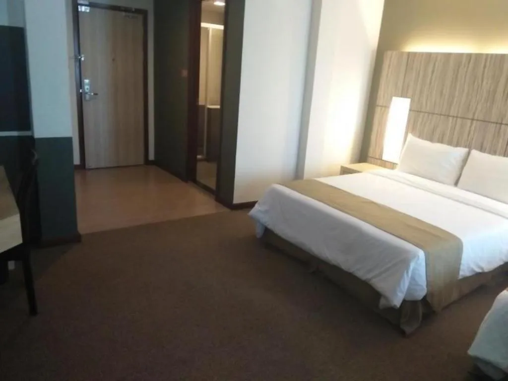 Bed in Grand Medallion Hotel