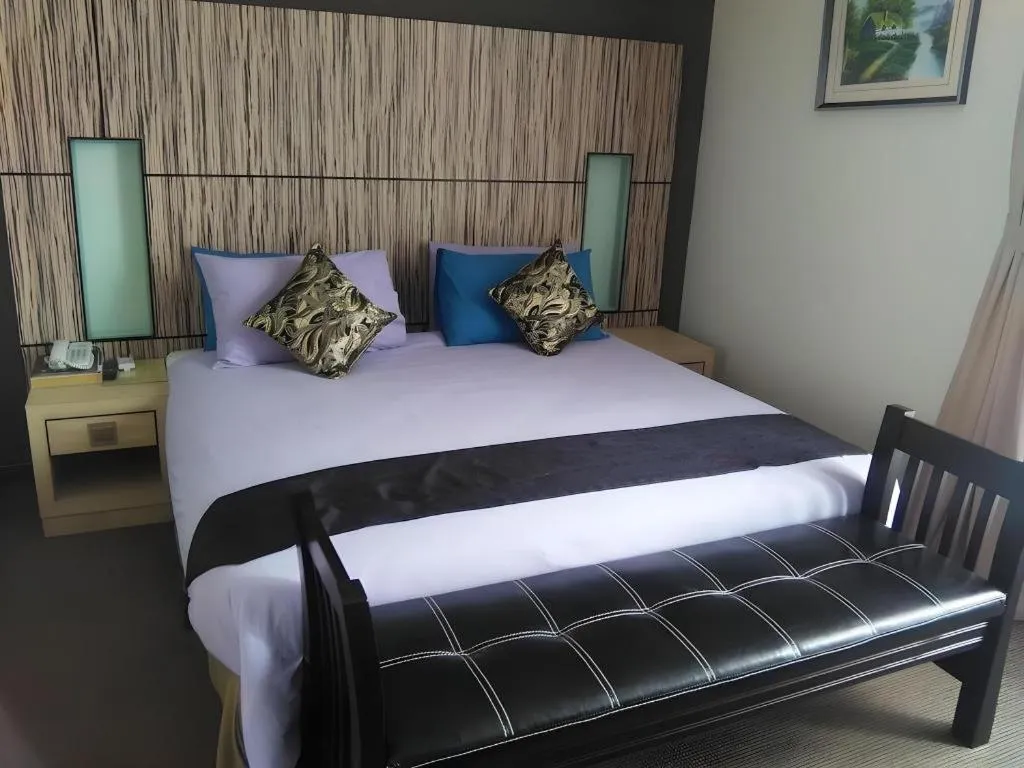 Bed in Grand Medallion Hotel