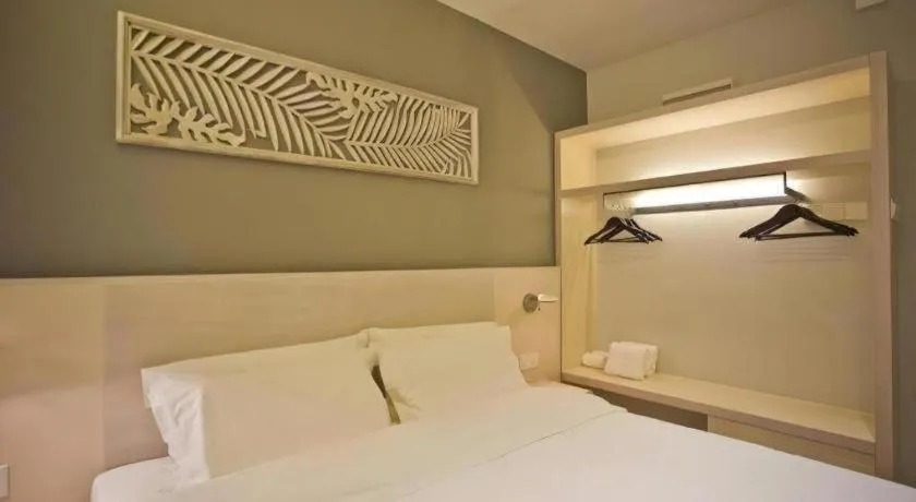 Bed in M Plus Boutique Hotel