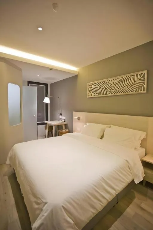 Bed in M Plus Boutique Hotel