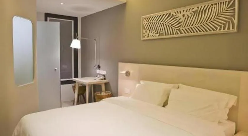 Bed in M Plus Boutique Hotel