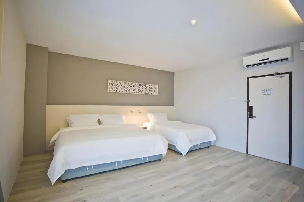 Bed in M Plus Boutique Hotel