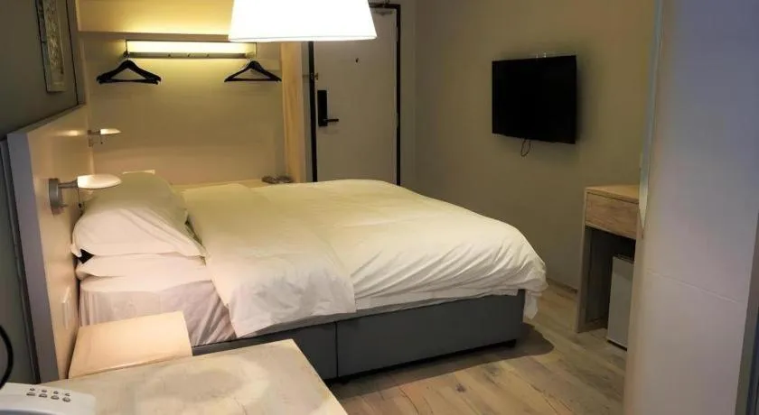 Bed in M Plus Boutique Hotel