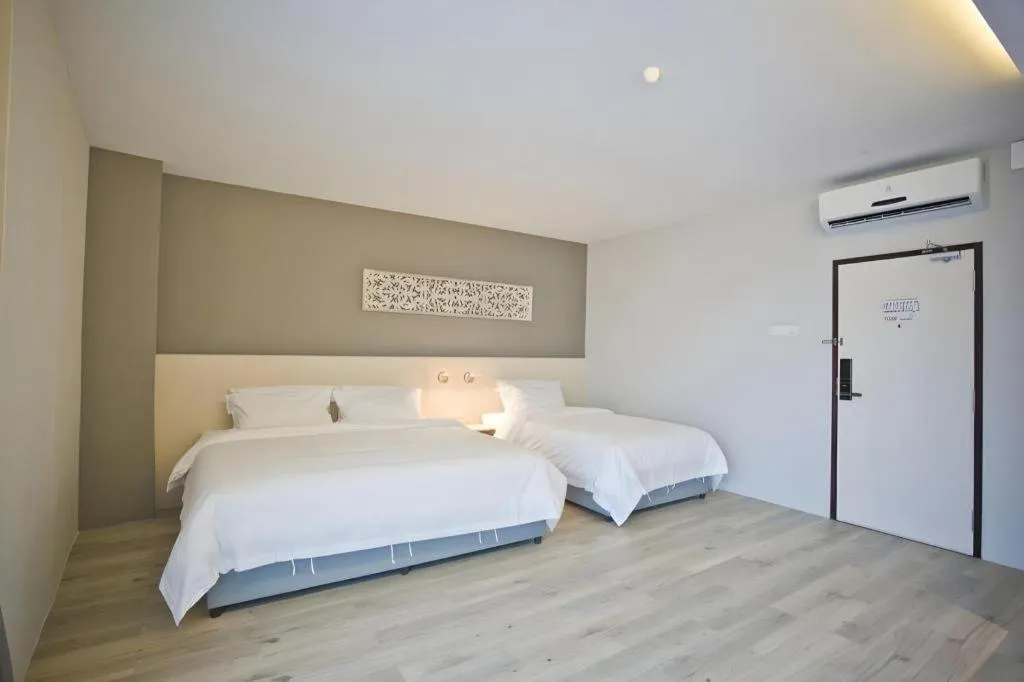 Bed in M Plus Boutique Hotel