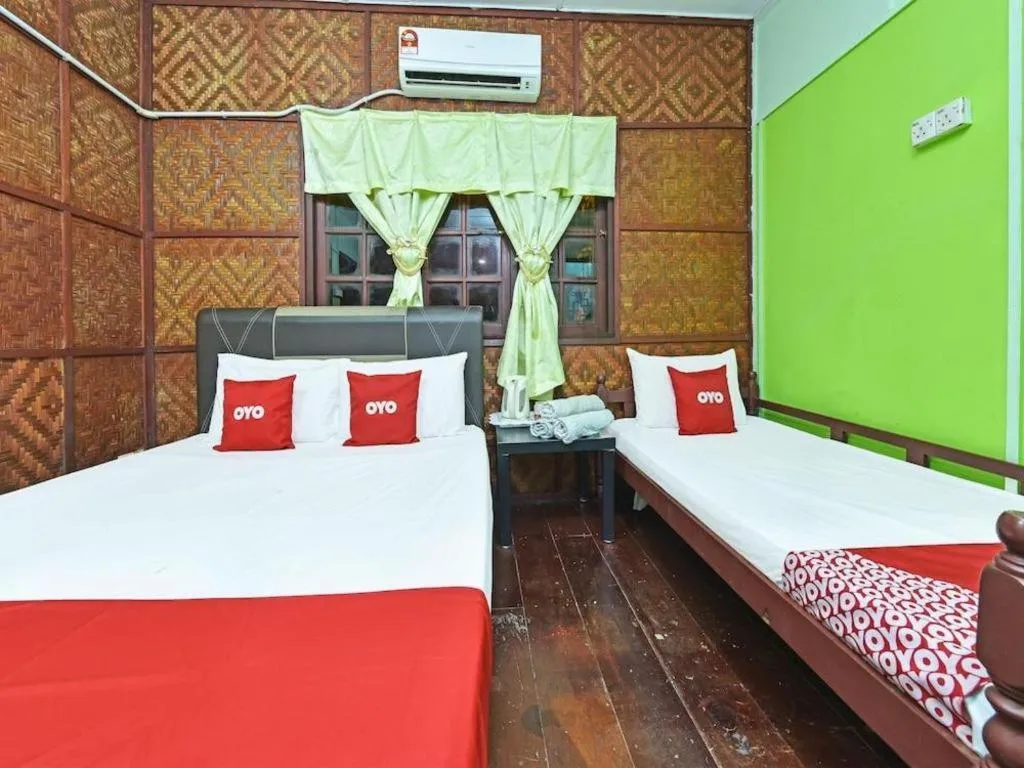 Bed in OYO 90620 Mahseer Chalet