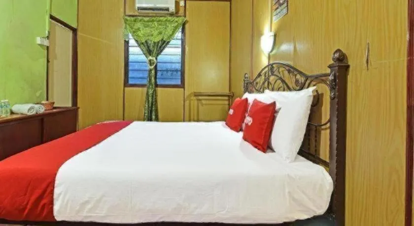 Bed in OYO 90620 Mahseer Chalet