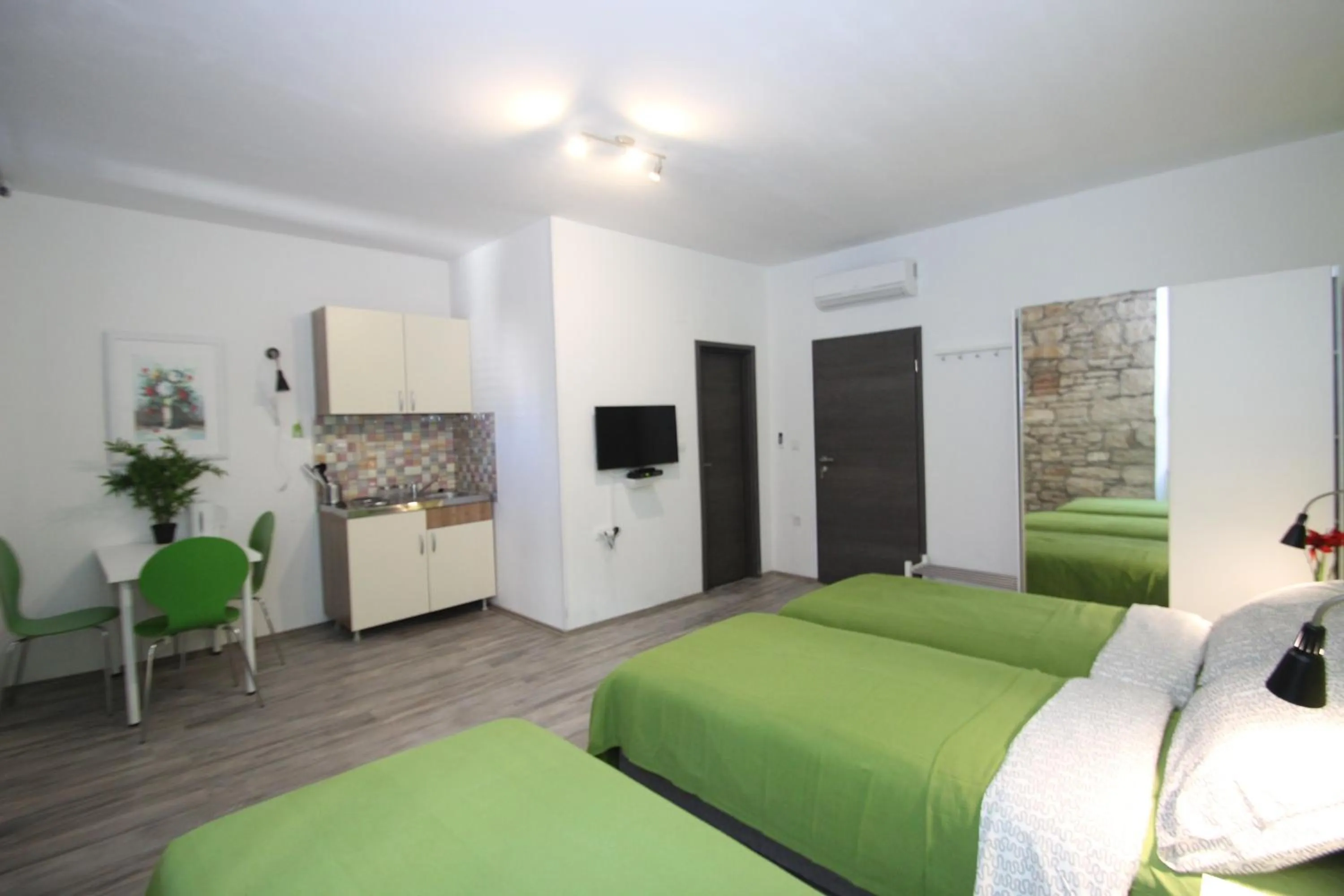 Photo of the whole room, Bed in Top Center Rooms & Studio