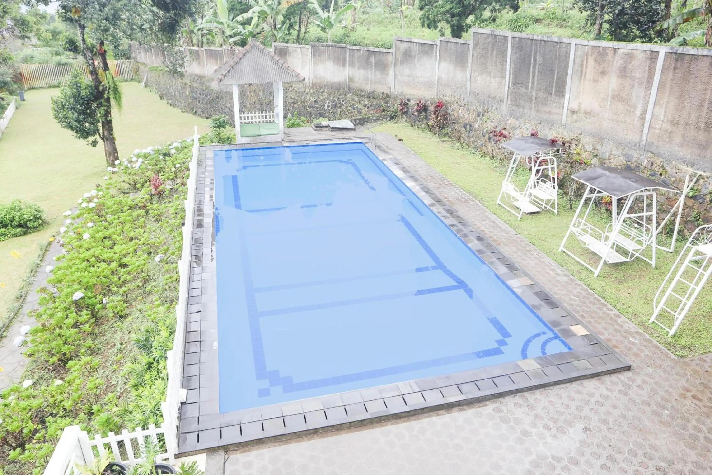 Swimming pool in Collection O Bogor Puncak Near Gunung Mas Formerly Villa Bunga Bunga