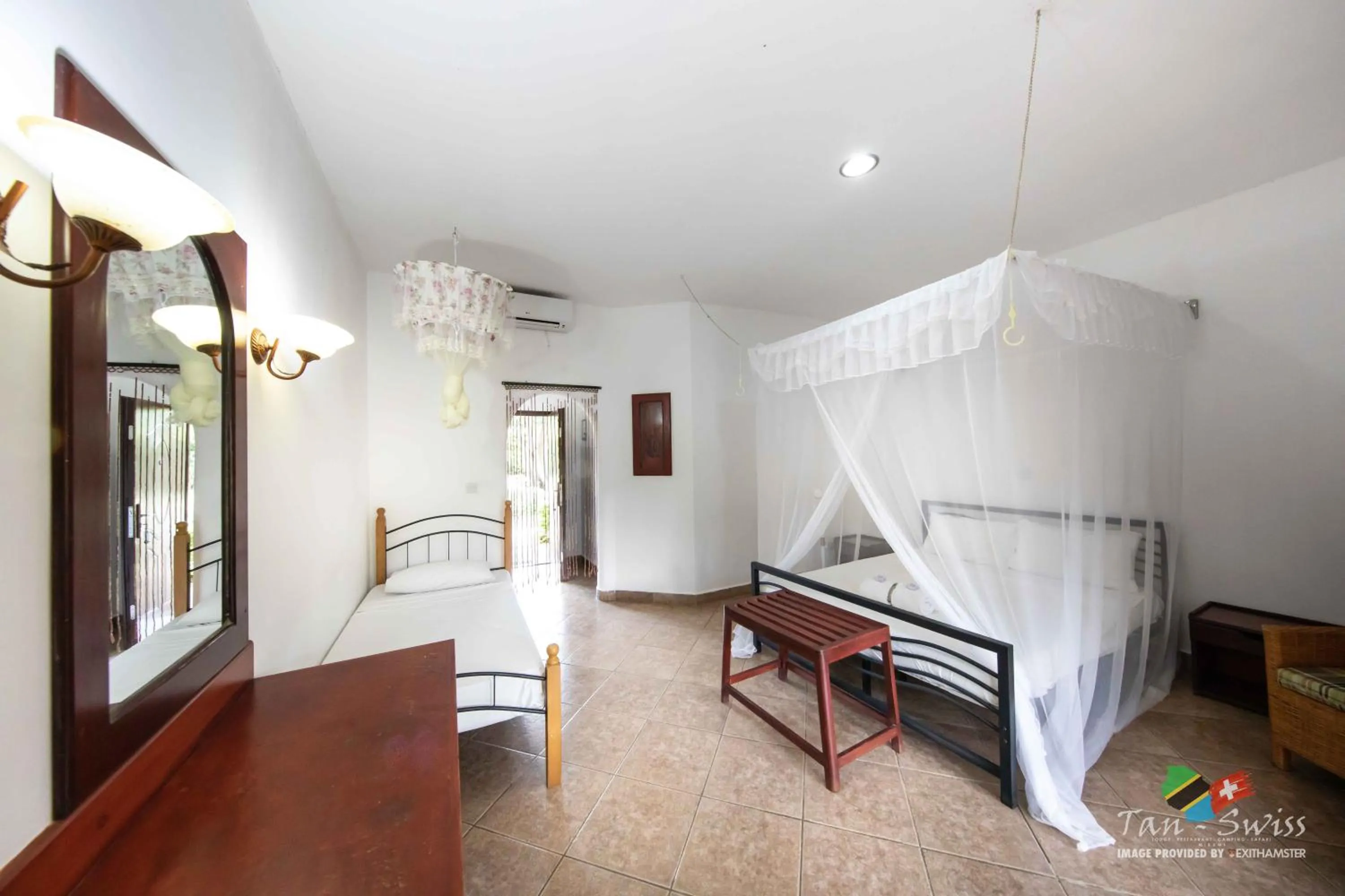 Photo of the whole room, Bed in Tan-Swiss Lodge