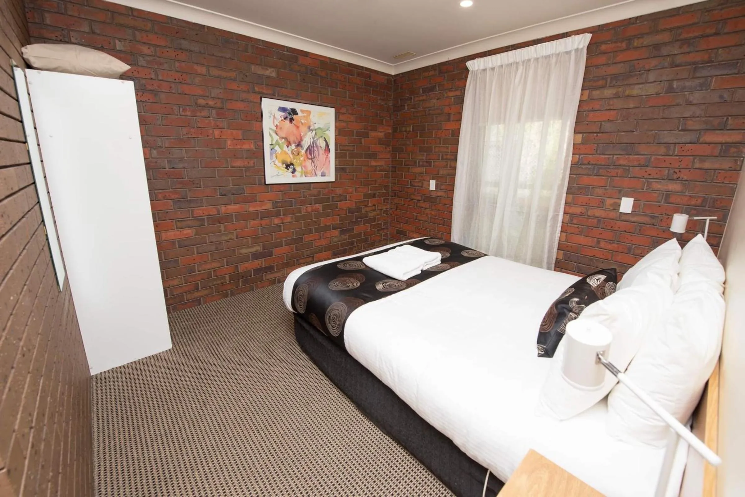 Bed in Jacaranda Holiday Units