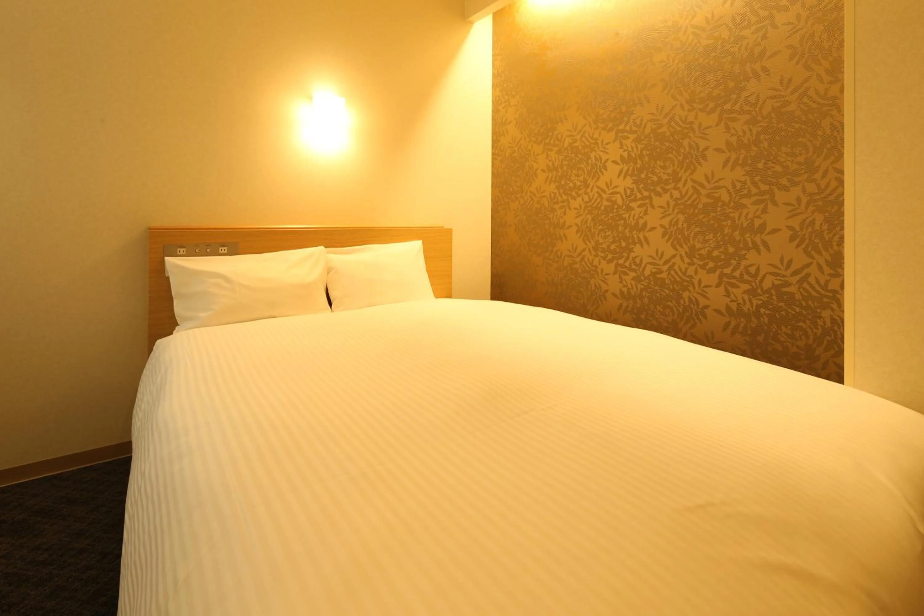 Bed in AB Hotel Sakaihigashi