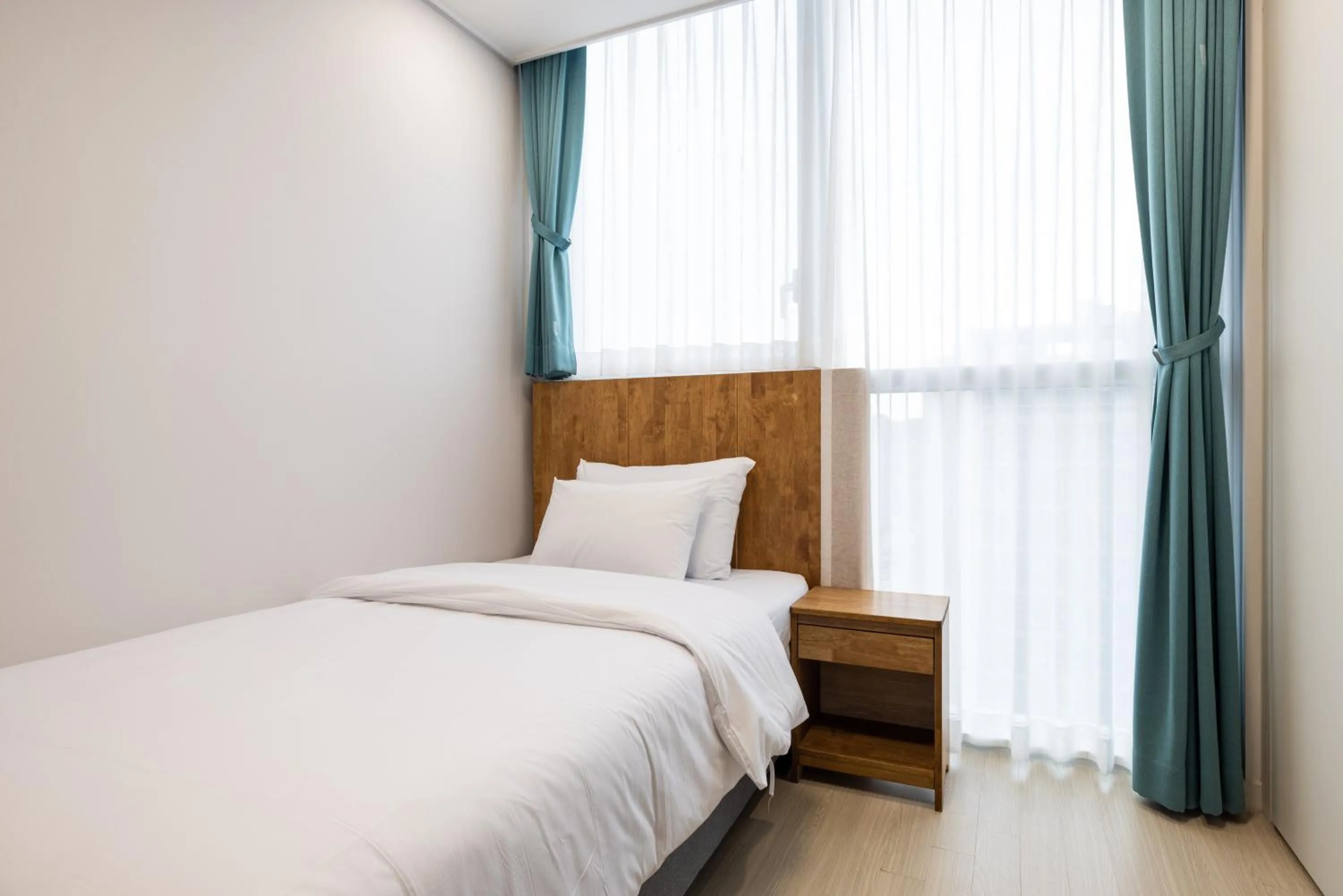 Bed in Grand Bleu Hotel & Residence