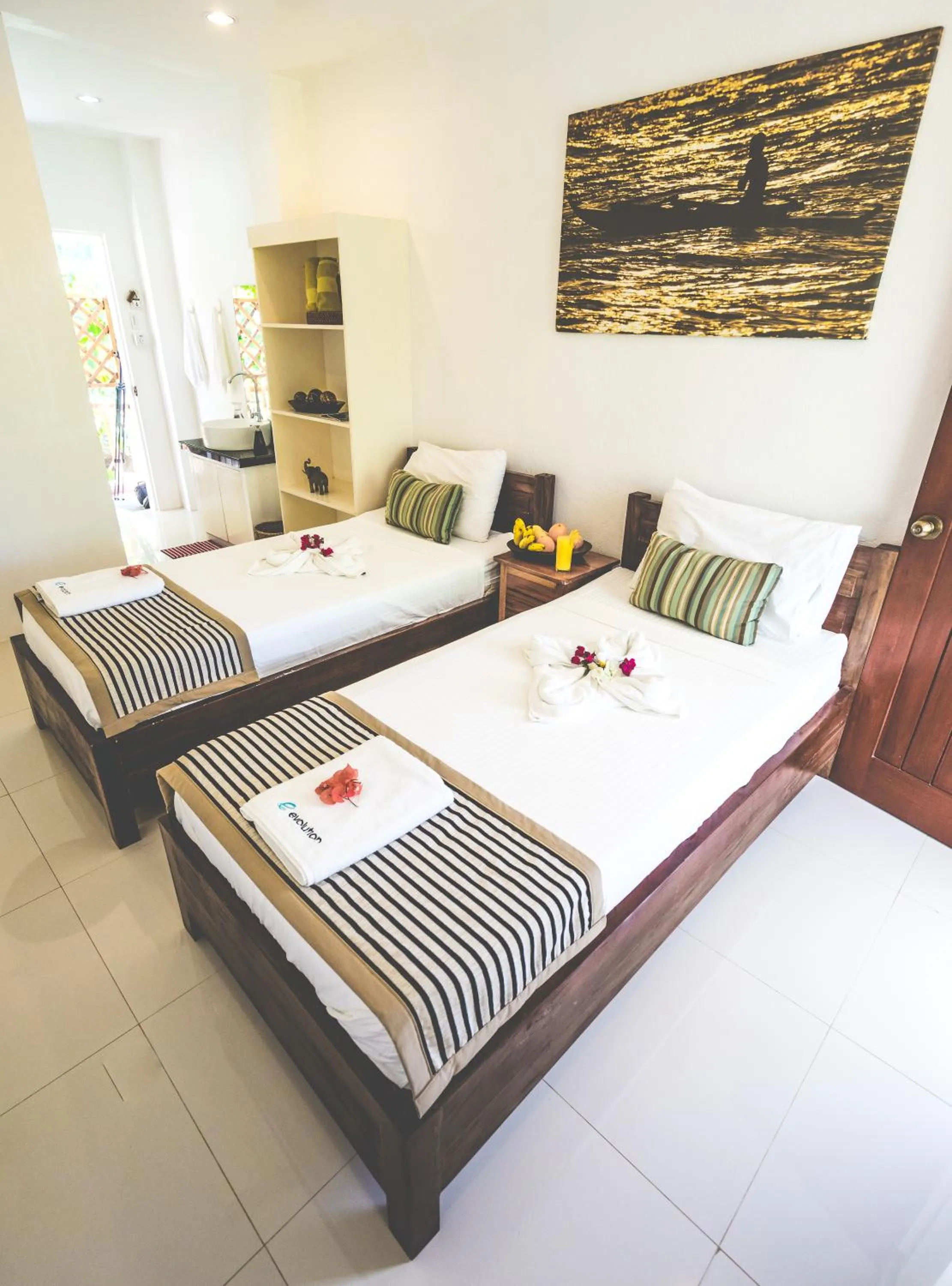 Photo of the whole room, Bed in Evolution Dive and Beach Resort