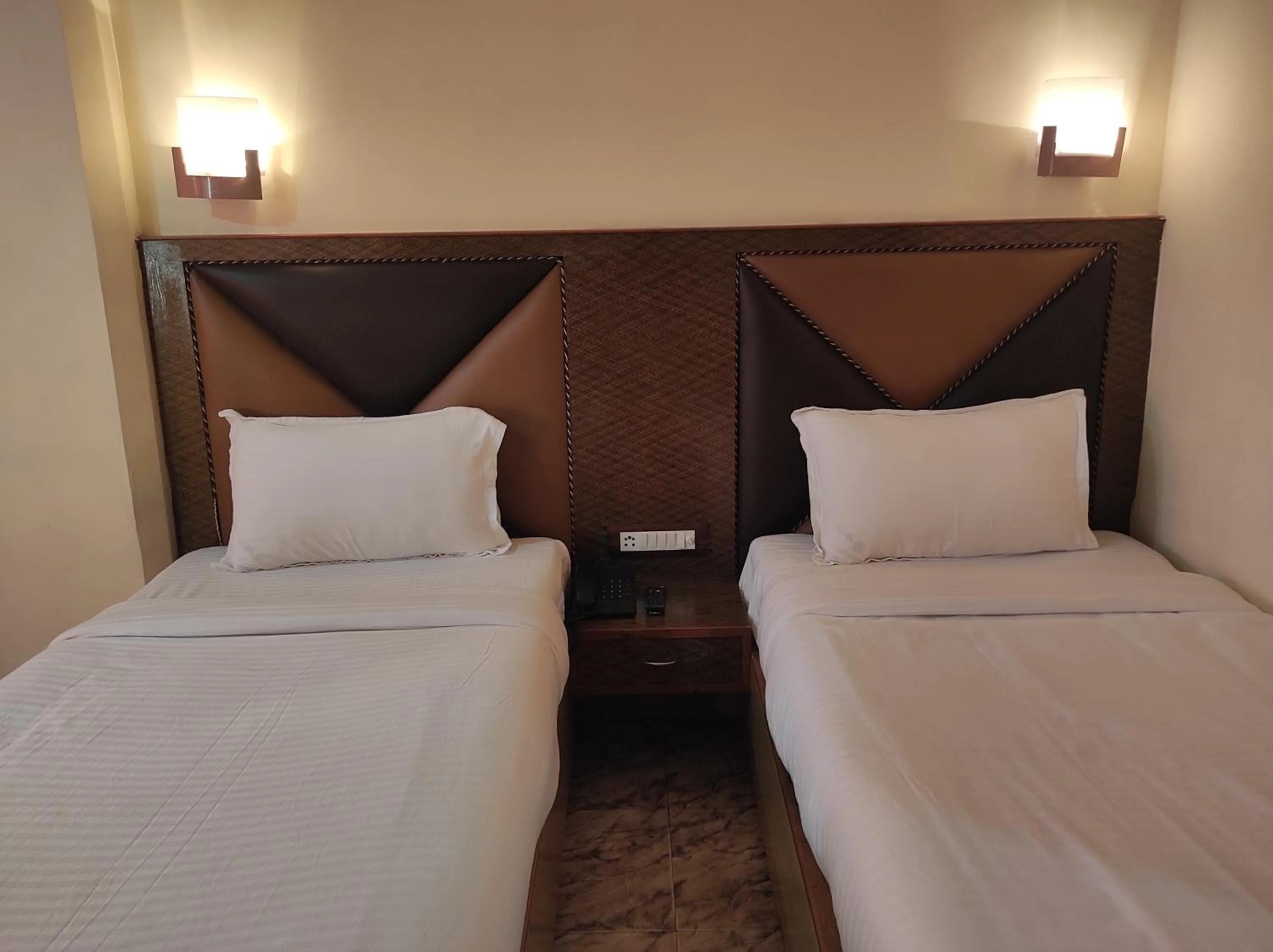 Bed in Hotel Ambarish Grand Residency