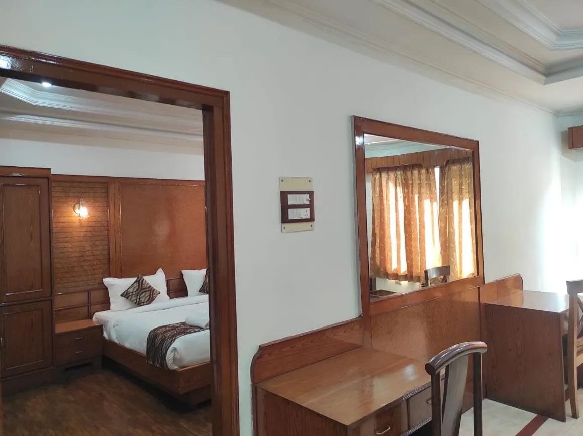 Bedroom in Hotel Ambarish Grand Residency