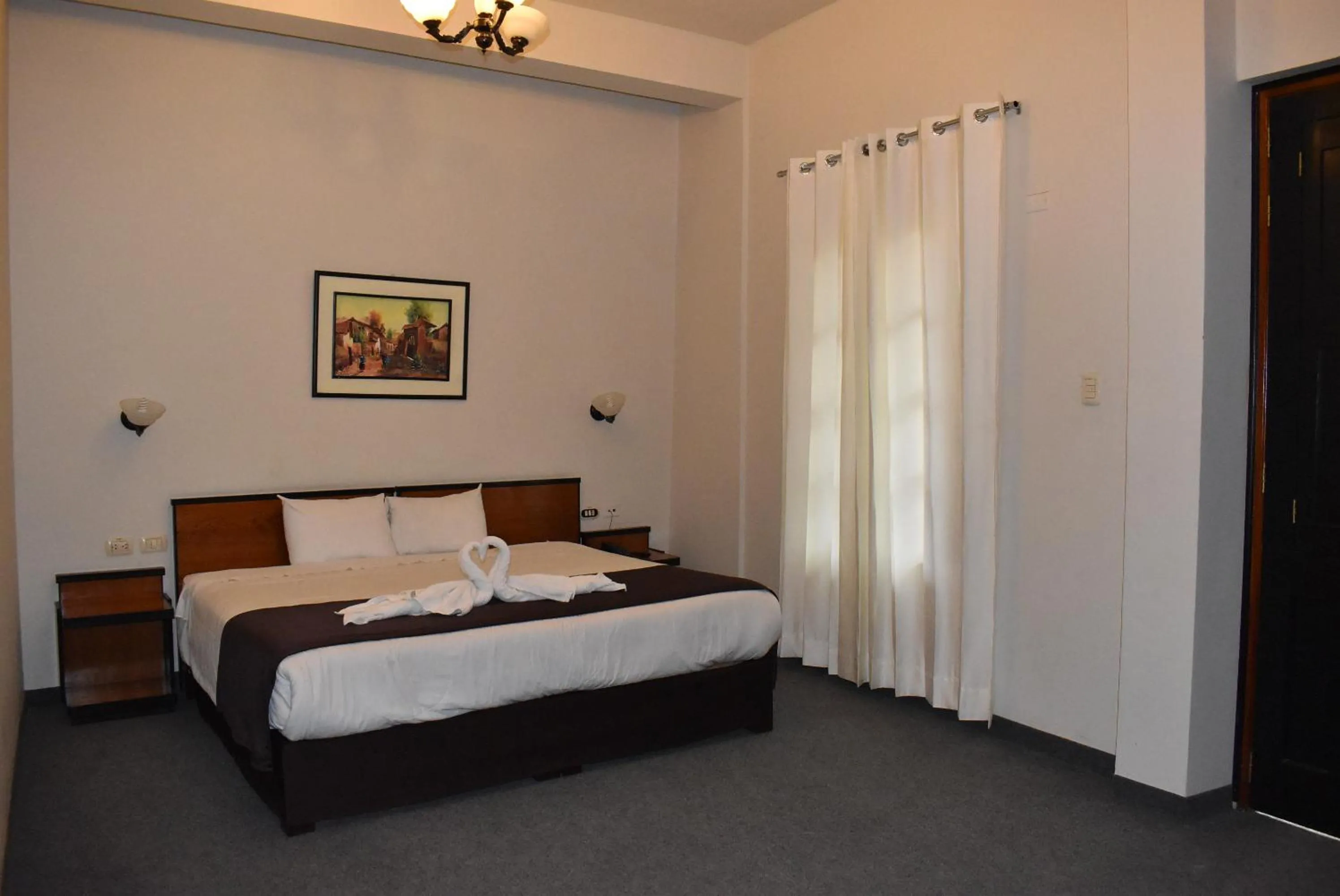 Bed in Colonial Plaza Hotel