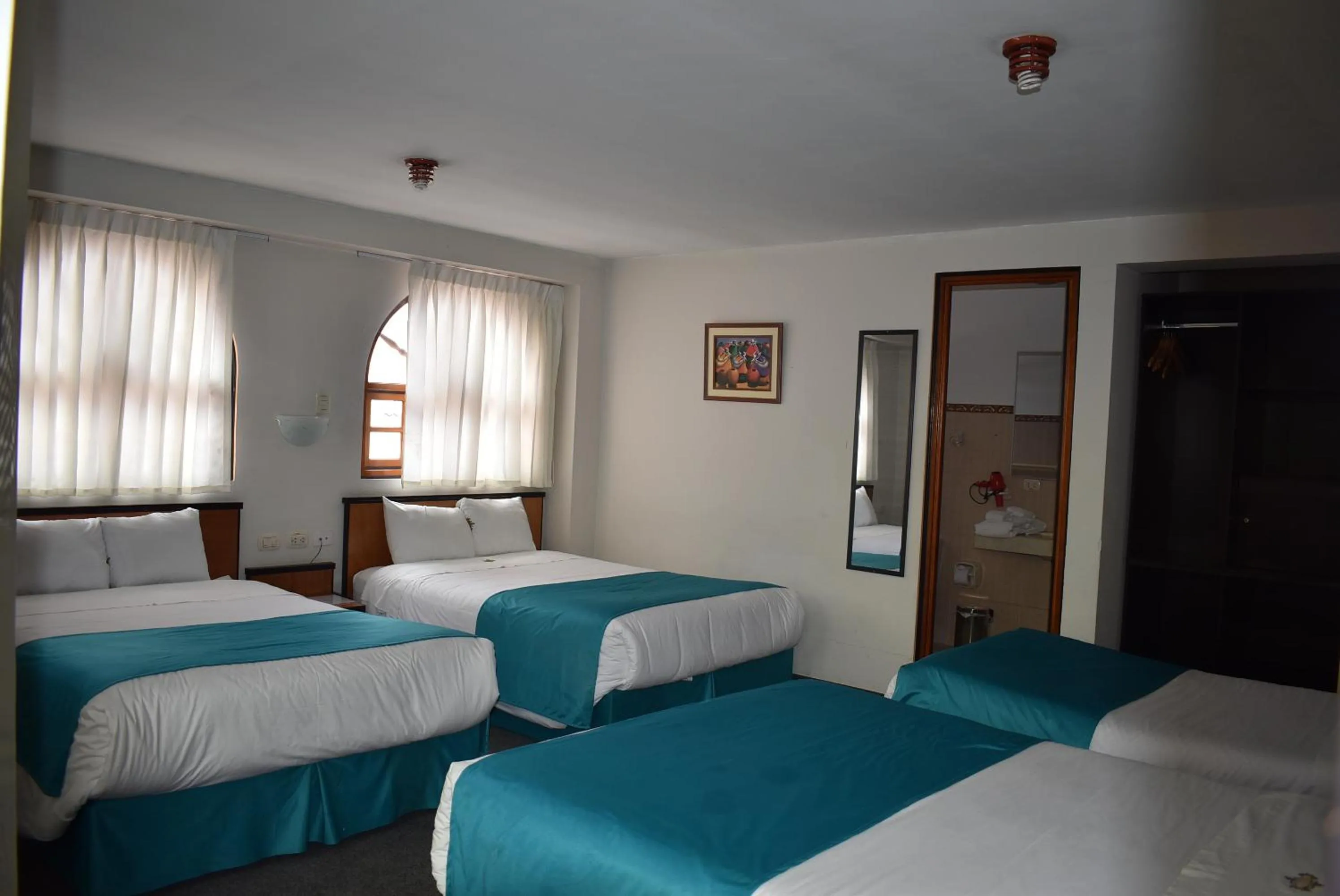 Bed in Colonial Plaza Hotel