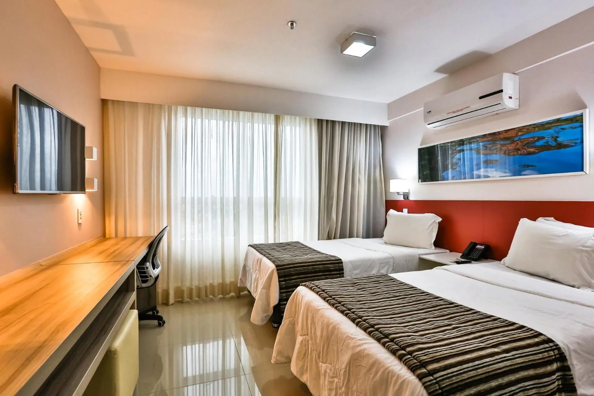 Bed in Ramada Hotel & Suites Campos Pelinca