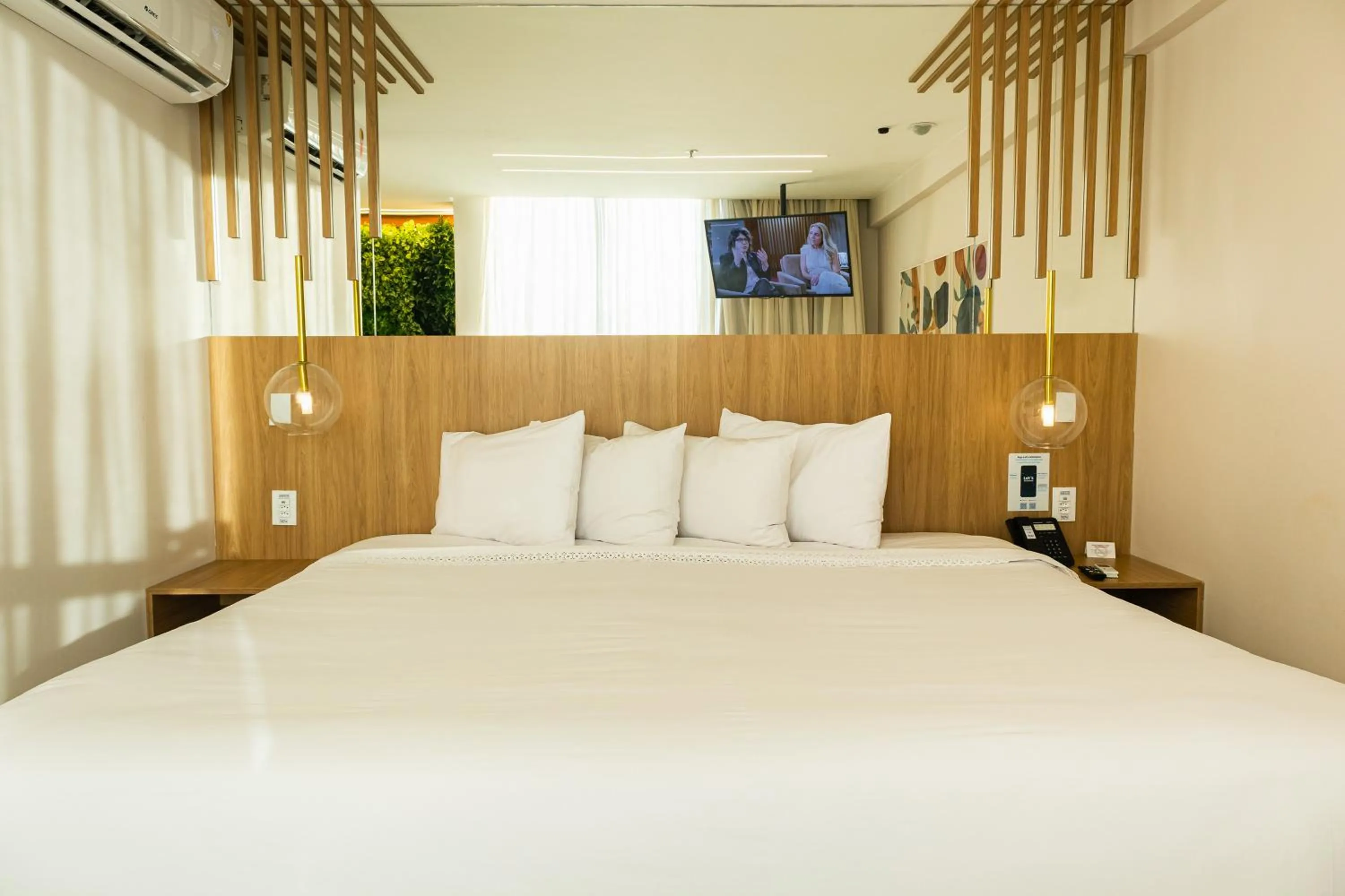 Bed in Ramada Hotel & Suites Campos Pelinca