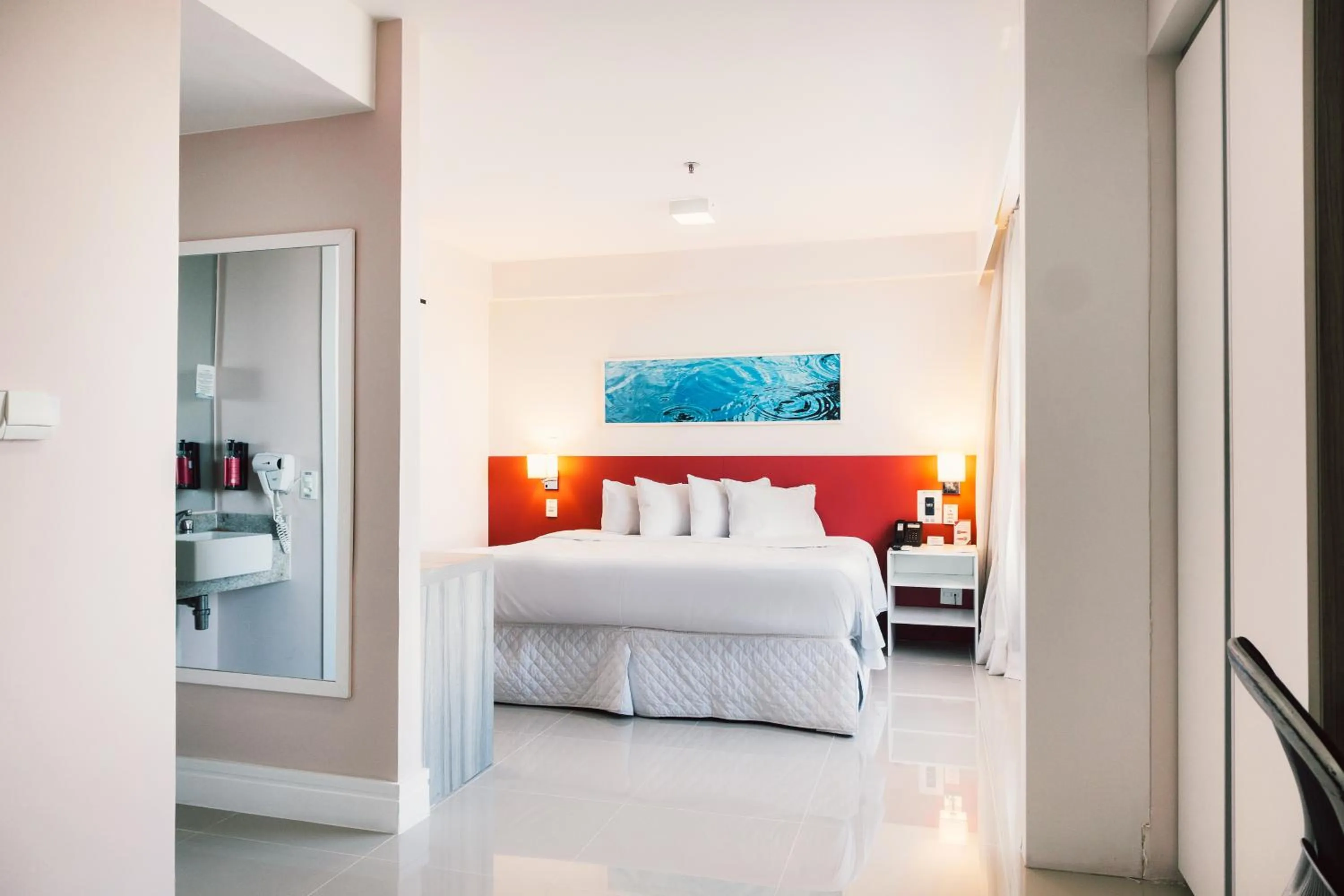 Bed in Ramada Hotel & Suites Campos Pelinca