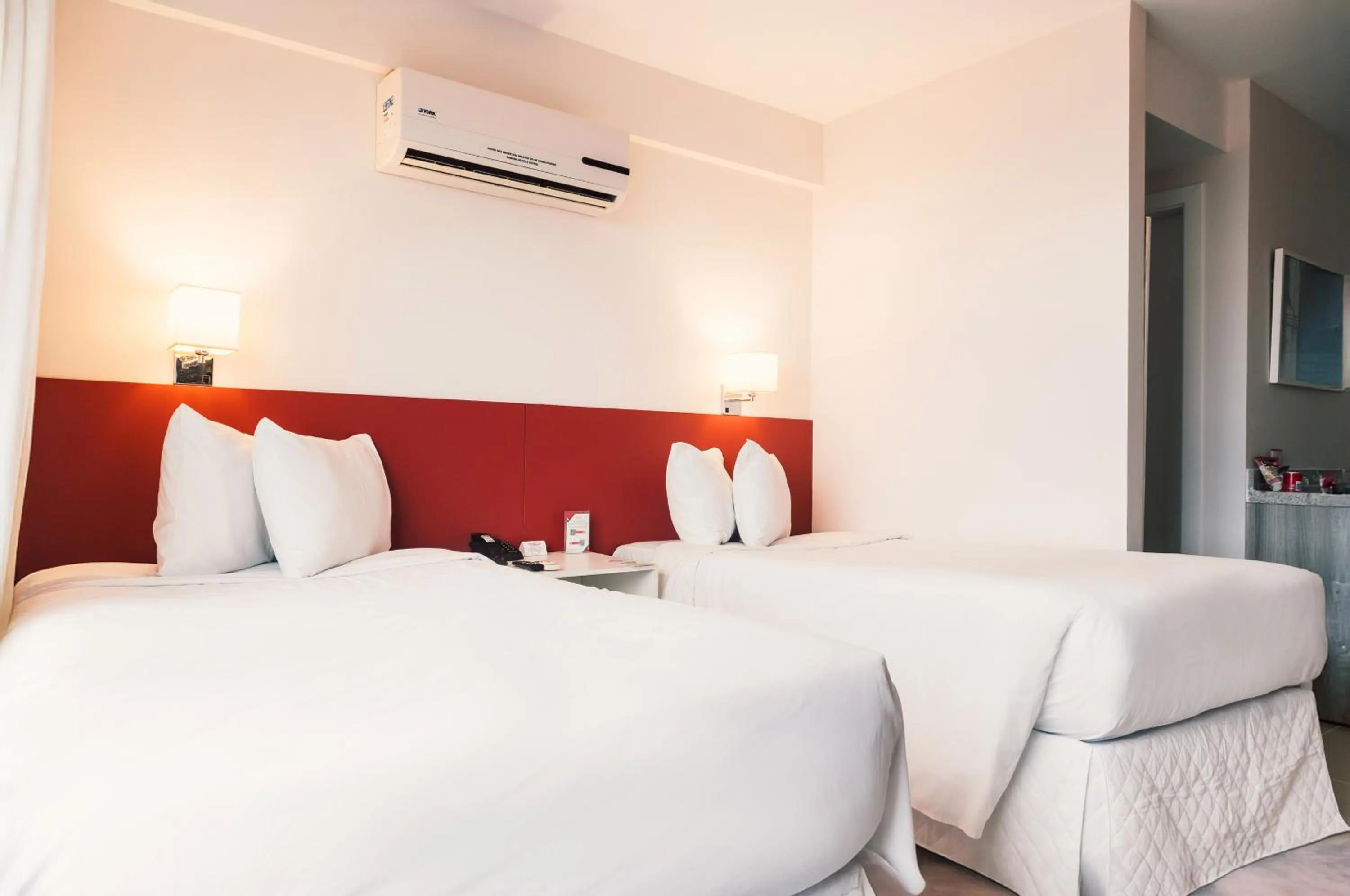 Bed in Ramada Hotel & Suites Campos Pelinca